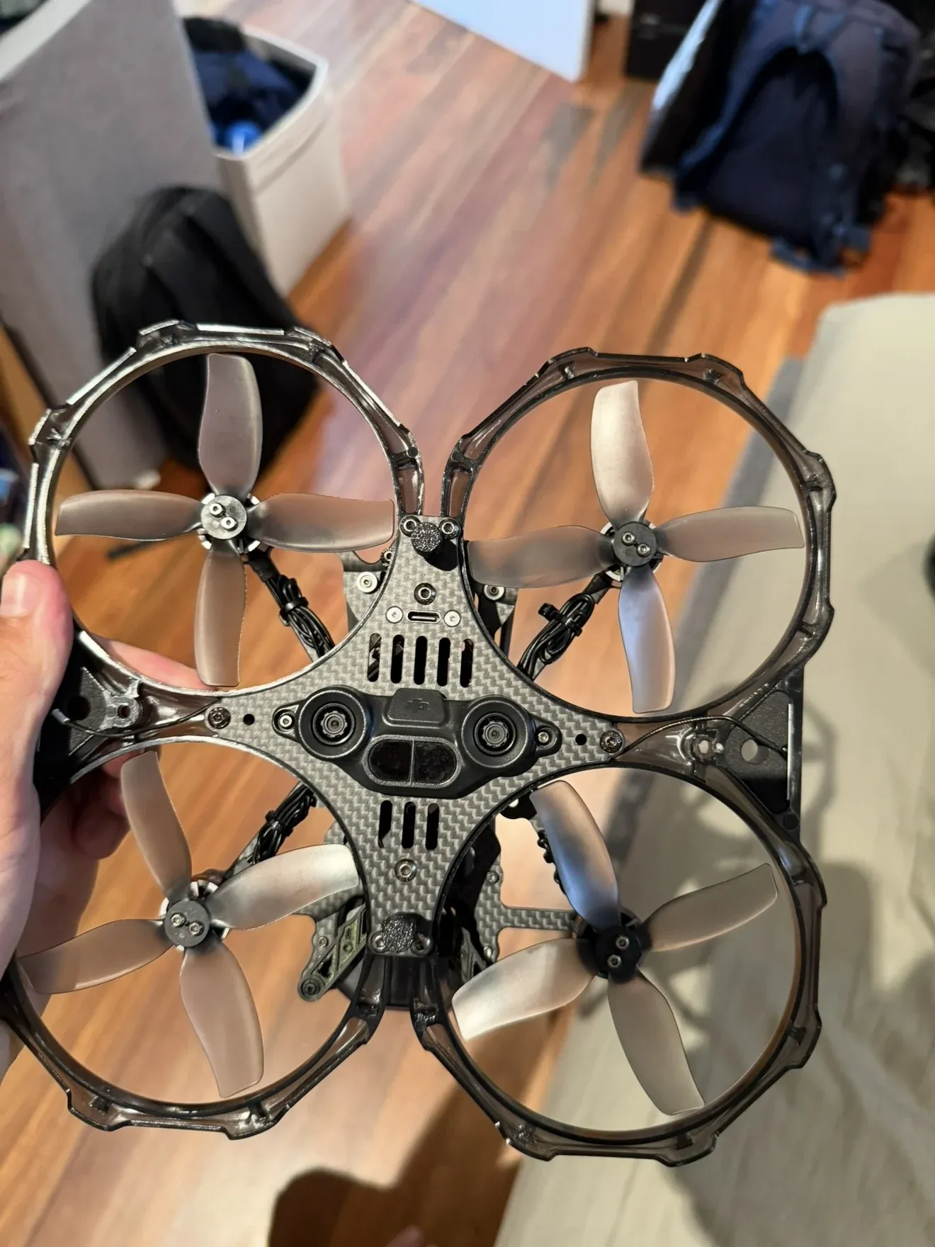 The modified Avata from below, showing the carbon fibre frame plate, the four ducted propellers and the larger motors.