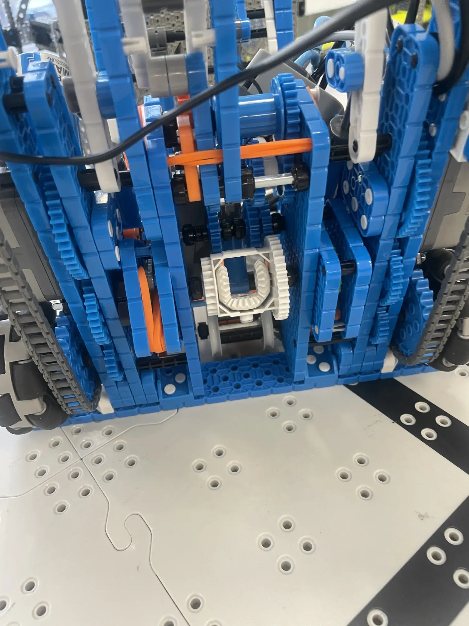 Close-up of the robot's blue differential drive, with tracks on both sides.